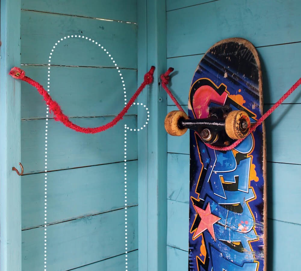 One skateboard mounted on the wall using a loop of rope.