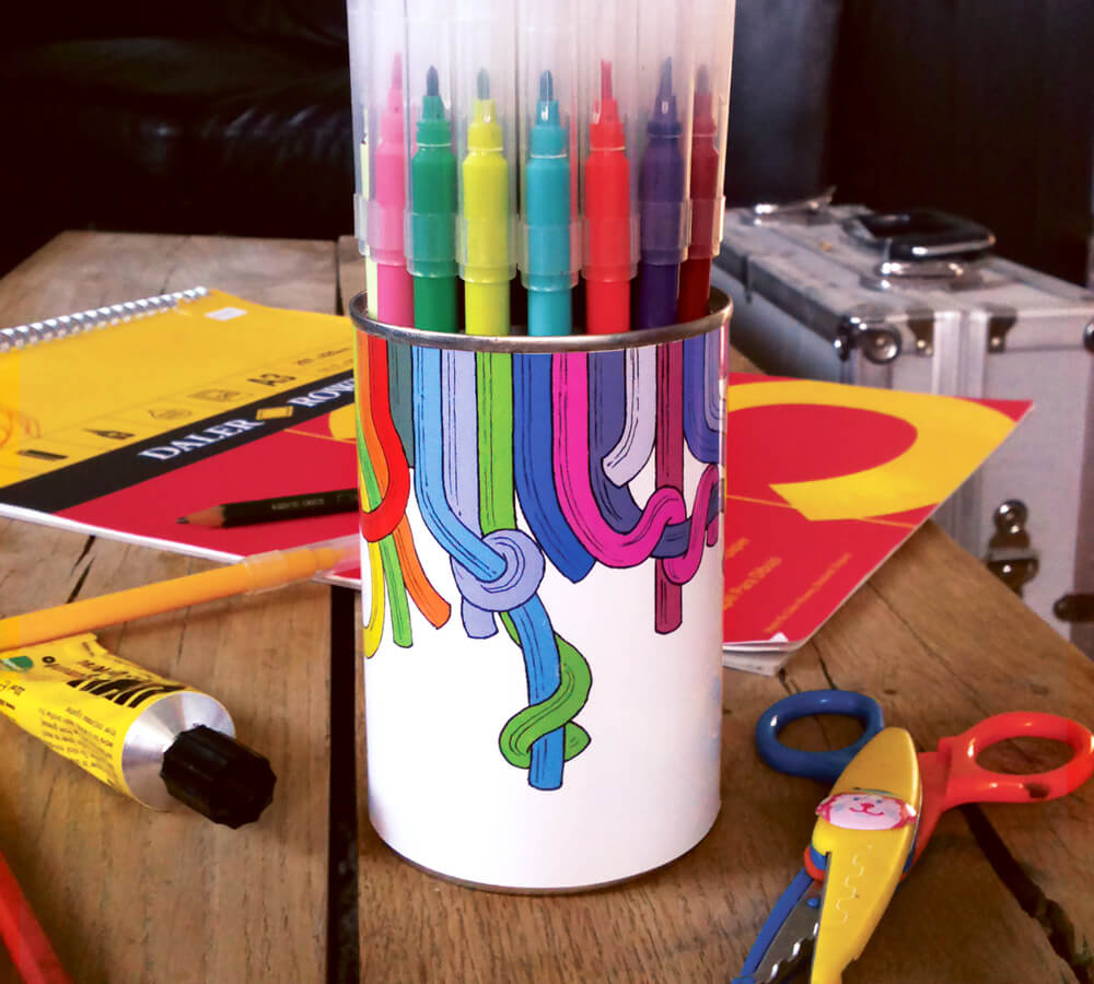 Tin can pen holder with a funky stick on label